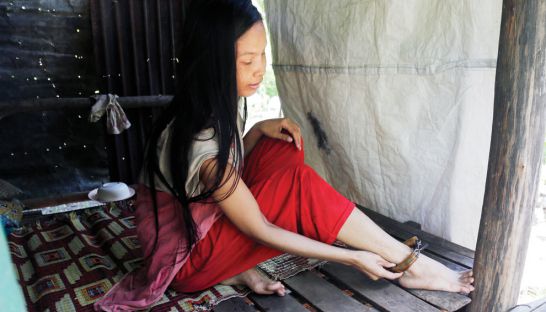 This woman worker has lose her memories, was sent back from Malaysia. She is kept at home to avoid running away. Photo: Heng Chivoan